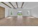 Expansive living room featuring wooden beam ceiling, and laminate flooring, filled with natural light at 534 War Eagle Ct., Conway, SC 29526