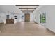 Spacious living area adjacent to a kitchen featuring a beamed ceiling, laminate floors and outdoor views at 534 War Eagle Ct., Conway, SC 29526