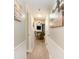 Inviting hallway leading to living room with fireplace and view of beach-themed artwork at 5523 N Ocean Blvd. # 1201, Myrtle Beach, SC 29577