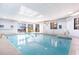 Large indoor pool with chairs and tables viewable through the windows at 5523 N Ocean Blvd. # 1201, Myrtle Beach, SC 29577