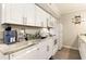 Kitchen featuring white cabinets and modern appliances including a dishwasher and oven at 5523 N Ocean Blvd. # 1201, Myrtle Beach, SC 29577