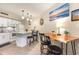 Kitchen with white cabinetry, island with bar stool seating, and a wood dining table at 5523 N Ocean Blvd. # 1201, Myrtle Beach, SC 29577