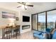 Living room featuring a modern fireplace, balcony access and ocean view at 5523 N Ocean Blvd. # 1201, Myrtle Beach, SC 29577
