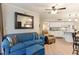 Living room flows into kitchen with white cabinets and seating at the kitchen island at 5523 N Ocean Blvd. # 1201, Myrtle Beach, SC 29577