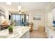 Living space with island seating flows to a balcony with ocean views in the distance at 5523 N Ocean Blvd. # 1201, Myrtle Beach, SC 29577