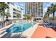 Community pool surrounded by lounge chairs and palm trees at 5523 N Ocean Blvd. # 1201, Myrtle Beach, SC 29577