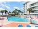 Bright outdoor pool area with palm trees and lounge chairs by the condominium building at 5523 N Ocean Blvd. # 1201, Myrtle Beach, SC 29577