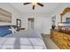 Bedroom with a bed, wooden dresser with TV, and an ensuite bathroom with a white shower curtain at 5801 Oyster Catcher Dr. # 1621, North Myrtle Beach, SC 29582
