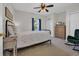 Comfortable bedroom with a ceiling fan, a metal frame bed, and a window with blue curtains at 5801 Oyster Catcher Dr. # 1621, North Myrtle Beach, SC 29582