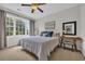 Inviting bedroom with large window providing natural light, complemented by a desk and soft furnishings at 5801 Oyster Catcher Dr. # 1621, North Myrtle Beach, SC 29582