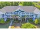 Aerial view of condo with nice balconies, palm trees, and well-maintained landscaping at 5801 Oyster Catcher Dr. # 1621, North Myrtle Beach, SC 29582