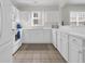 Bright kitchen featuring white cabinetry, modern appliances, and ceramic tile floors at 5801 Oyster Catcher Dr. # 1621, North Myrtle Beach, SC 29582