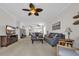 Open living area with ceiling fans, gray sofas, neutral walls and carpeting at 5801 Oyster Catcher Dr. # 1621, North Myrtle Beach, SC 29582