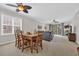 Bright dining and living room with neutral carpet, ceiling fan, and sliding glass doors at 5801 Oyster Catcher Dr. # 1621, North Myrtle Beach, SC 29582