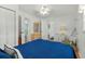 Relaxing bedroom features a queen bed with blue bedding, a ceiling fan, and ample closet space at 6001- 1776 S Kings Highway, Myrtle Beach, SC 29575