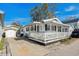 This home features a large front porch and bright white exterior at 6001- 1776 S Kings Highway, Myrtle Beach, SC 29575