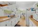 Open kitchen with white cabinets, wood counters, and an adjacent dining area for easy entertaining at 6001- 1776 S Kings Highway, Myrtle Beach, SC 29575