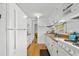 Well-lit kitchen featuring white cabinets, wood counters, and modern appliances for efficient meal preparation at 6001- 1776 S Kings Highway, Myrtle Beach, SC 29575