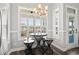 Bright dining area with a round table and four stools, enhanced by natural light through shuttered windows at 6001- 5432 S Kings Highway, Myrtle Beach, SC 29575