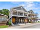 Two-story coastal home featuring a covered porch, ground-level parking, and durable gray siding at 6001- 5432 S Kings Highway, Myrtle Beach, SC 29575