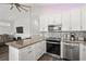 Modern kitchen featuring stainless steel appliances, granite countertops, and an open layout to the living area at 6001- 5432 S Kings Highway, Myrtle Beach, SC 29575
