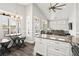 Open kitchen and dining area with modern finishes, a table with stools, and bright natural light from shuttered windows at 6001- 5432 S Kings Highway, Myrtle Beach, SC 29575