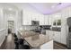 Modern kitchen with white cabinets, granite countertops, stainless steel appliances, and stylish backsplash at 6001- 5432 S Kings Highway, Myrtle Beach, SC 29575