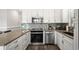 Well-equipped kitchen with granite countertops, stainless steel appliances, and white cabinetry, offering a modern aesthetic at 6001- 5432 S Kings Highway, Myrtle Beach, SC 29575
