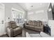 Well-lit living room with vaulted ceilings, plantation shutters, and comfortable seating at 6001- 5432 S Kings Highway, Myrtle Beach, SC 29575