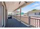 Large porch area with durable flooring, black metal railing, and open-air views at 6001- 5432 S Kings Highway, Myrtle Beach, SC 29575
