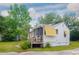 This image features the back of the home with a screened porch and lush green foliage at 640 Willowbank Rd., Georgetown, SC 29440