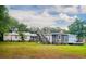 An elevated porch connects two sections of the home in this expansive backyard scene at 640 Willowbank Rd., Georgetown, SC 29440