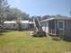 Spacious backyard featuring a multi-level deck, grassy lawn, and a screened-in porch at 640 Willowbank Rd., Georgetown, SC 29440
