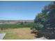 A beautiful backyard view showcases an expansive grassy lawn meeting a serene marshland, all under a clear blue sky at 640 Willowbank Rd., Georgetown, SC 29440