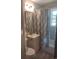 Cozy bathroom with shower/tub combo, patterned shower curtain, tile, and decorative gold framed mirror at 640 Willowbank Rd., Georgetown, SC 29440