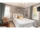 Well-lit bedroom features a queen size bed and tiger print side chair at 640 Willowbank Rd., Georgetown, SC 29440