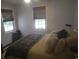 Comfortable bedroom with two windows, cozy bedding, and dark-toned wooden window blinds at 640 Willowbank Rd., Georgetown, SC 29440