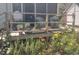 Wooden deck area with colorful flower garden, plants in pots, seating, and wooden railing at 640 Willowbank Rd., Georgetown, SC 29440