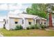 An eye-level view shows the side and front of a charming white cottage-style home at 640 Willowbank Rd., Georgetown, SC 29440