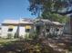 Quaint single story home with metal roof, yellow awnings, mature trees, and brick pathway at 640 Willowbank Rd., Georgetown, SC 29440