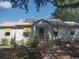 Attractive one-story home featuring metal roof, yellow awnings, mature trees, and manicured lawn at 640 Willowbank Rd., Georgetown, SC 29440