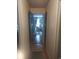 Hallway with hardwood floors leading to a bedroom with natural lighting and neutral paint at 640 Willowbank Rd., Georgetown, SC 29440