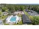 Aerial view of community amenities, including pool, clubhouse, pickleball court, and parking at 6465 Royal Pine Dr., Myrtle Beach, SC 29588