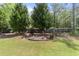 Lush backyard featuring mature trees, a garden bed, and a well-maintained lawn, creating a serene outdoor space at 6465 Royal Pine Dr., Myrtle Beach, SC 29588