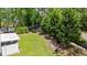Expansive backyard with lush green lawn and bordered by mature trees at 6465 Royal Pine Dr., Myrtle Beach, SC 29588