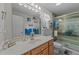Bright bathroom with a vanity, sink, large mirror, and modern walk-in shower at 6465 Royal Pine Dr., Myrtle Beach, SC 29588