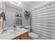 Cozy bathroom with neutral walls, white vanity, and a charming striped shower curtain at 6465 Royal Pine Dr., Myrtle Beach, SC 29588