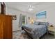 Comfortable bedroom featuring a ceiling fan, plush bedding, and soothing beach-themed artwork at 6465 Royal Pine Dr., Myrtle Beach, SC 29588