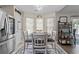 Bright dining area features a round table, four chairs, a patterned rug, and natural light from the windows at 6465 Royal Pine Dr., Myrtle Beach, SC 29588