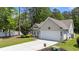 Inviting single story home featuring a two-car garage, well-maintained lawn, and mature trees at 6465 Royal Pine Dr., Myrtle Beach, SC 29588